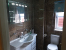 The main bathroom with an LED lit mirror and a heated towel rail.